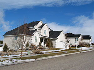 Beautiful white 2-story house on a hillside street in Pocatello